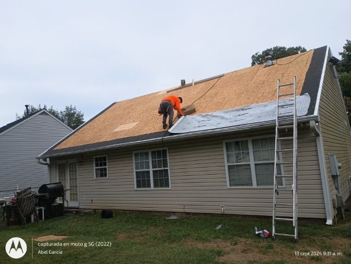 Man on a roof repairing shingles