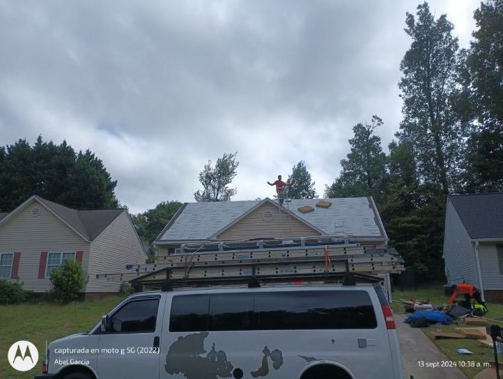 Roofer on a house roof