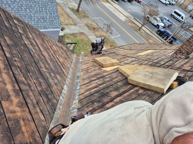 Person on a roof installing gutter