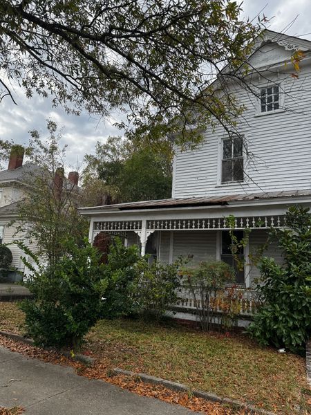 White two-story house with a porch