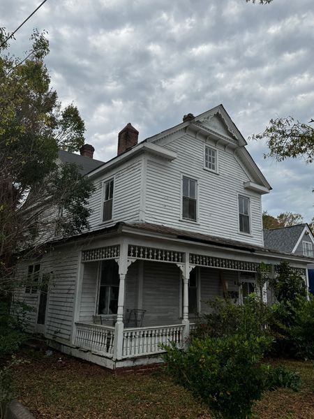 Two-story white house with porch