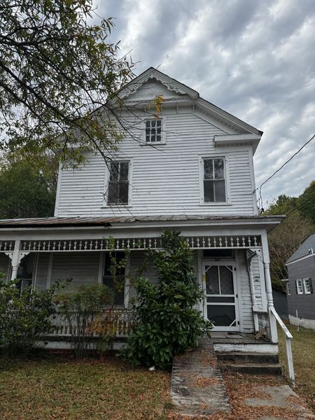 Two-story white house with porch and steps