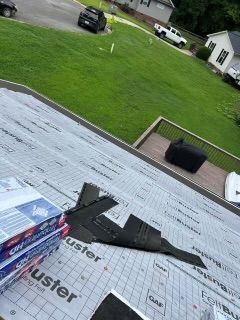 Black model airplane on a rooftop