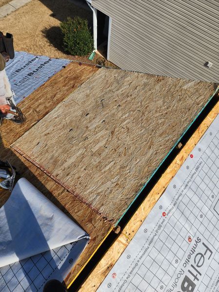 A rooftop with exposed plywood