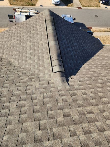 A rooftop covered in brown shingles