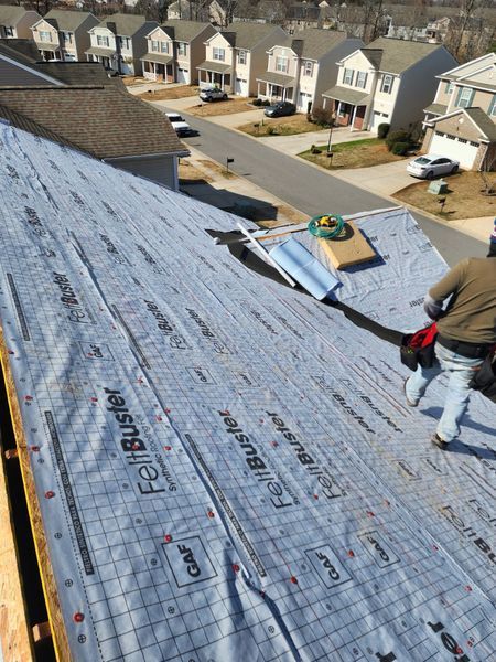 Roofer on a house roof