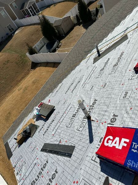 Roof partially covered with gray shingles