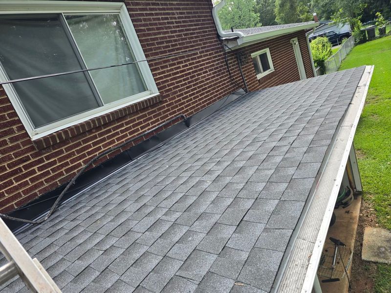 Gray asphalt shingle roof on a brick house
