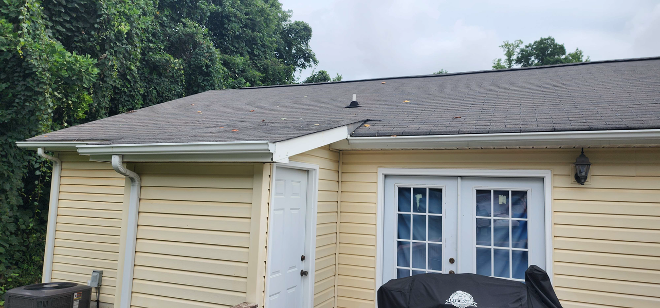 Yellow house with dark roof and white trim