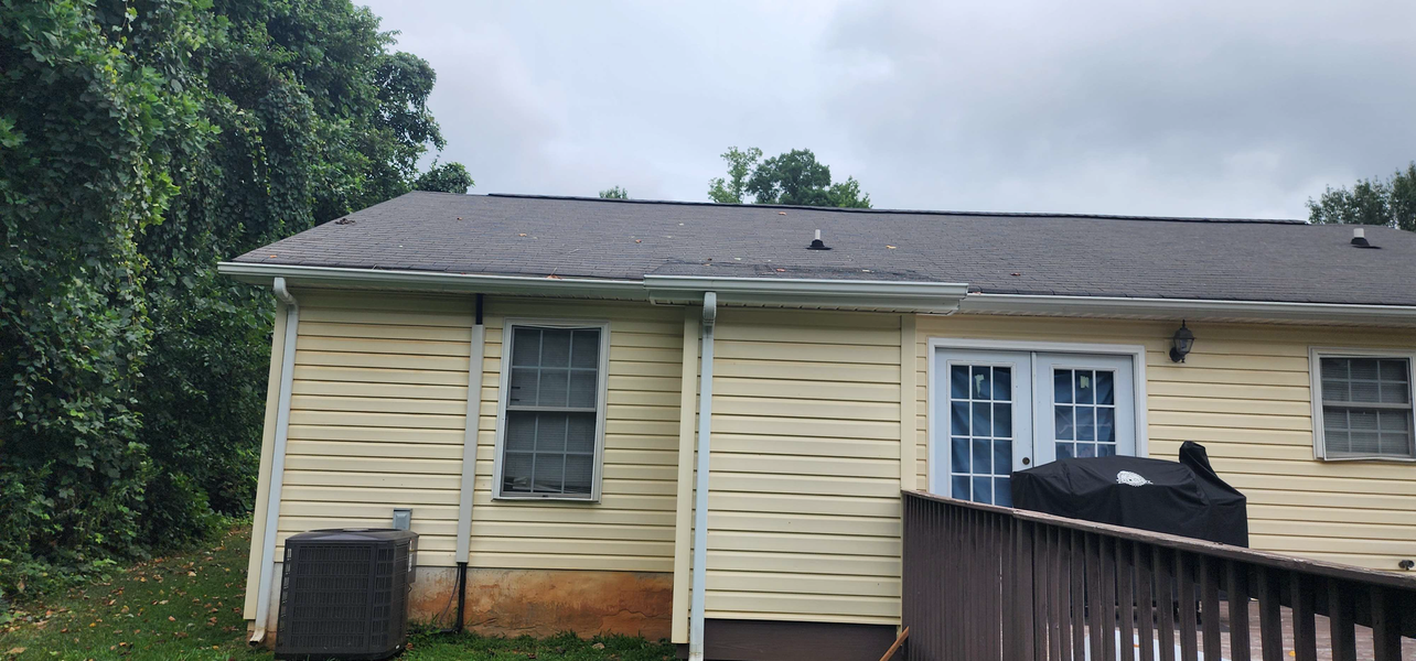 Back of a house with a dark roof