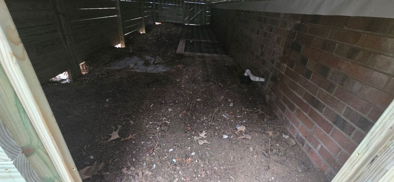 A crawl space with a brick wall