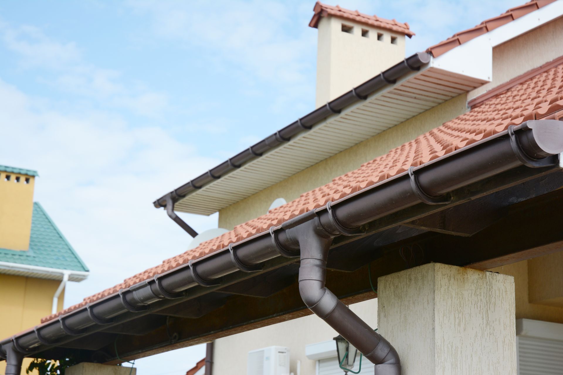 Brown gutters along a house roof