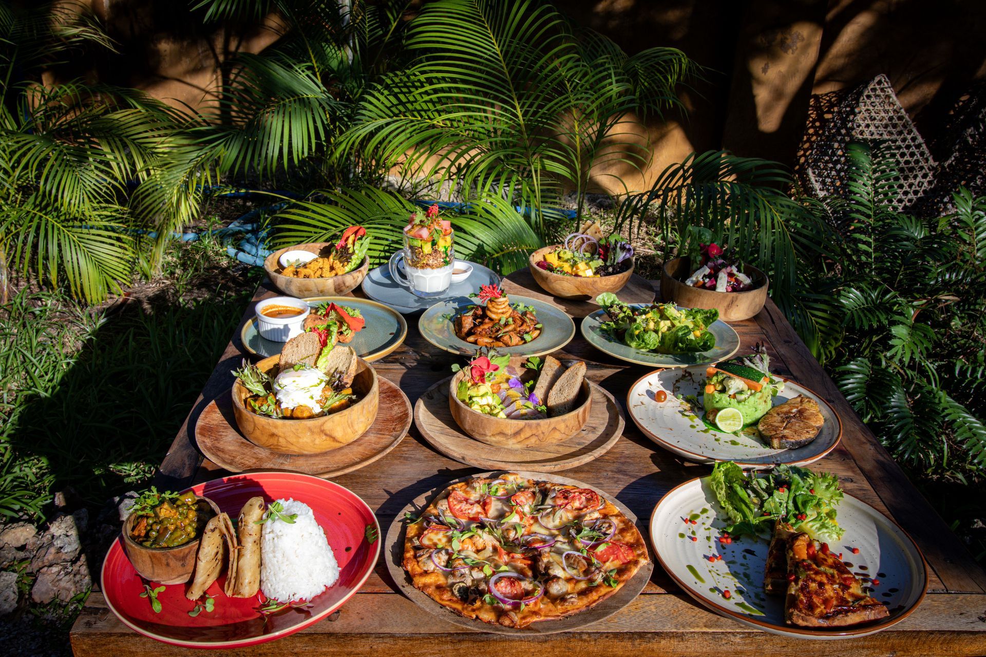 A man and a woman standing behind a counter in front of a sign that says cocktails