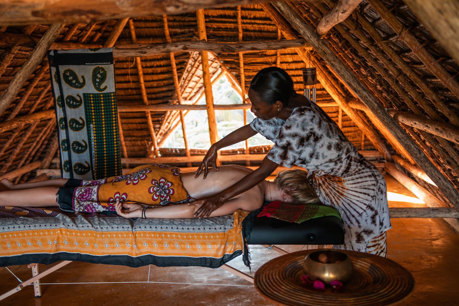 A man and a woman are standing at a counter in front of a sign that says cocktails