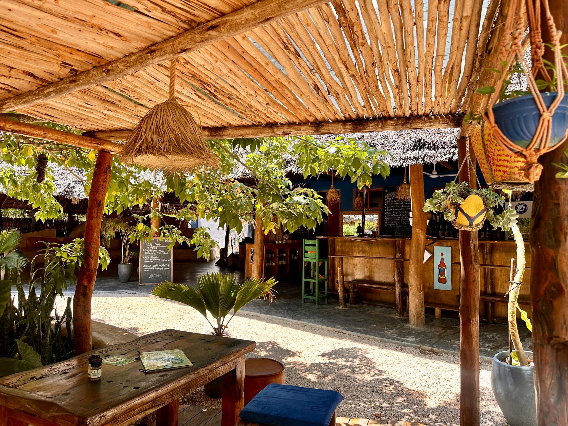 A man in a chef 's hat is rolling dough on a wooden table.