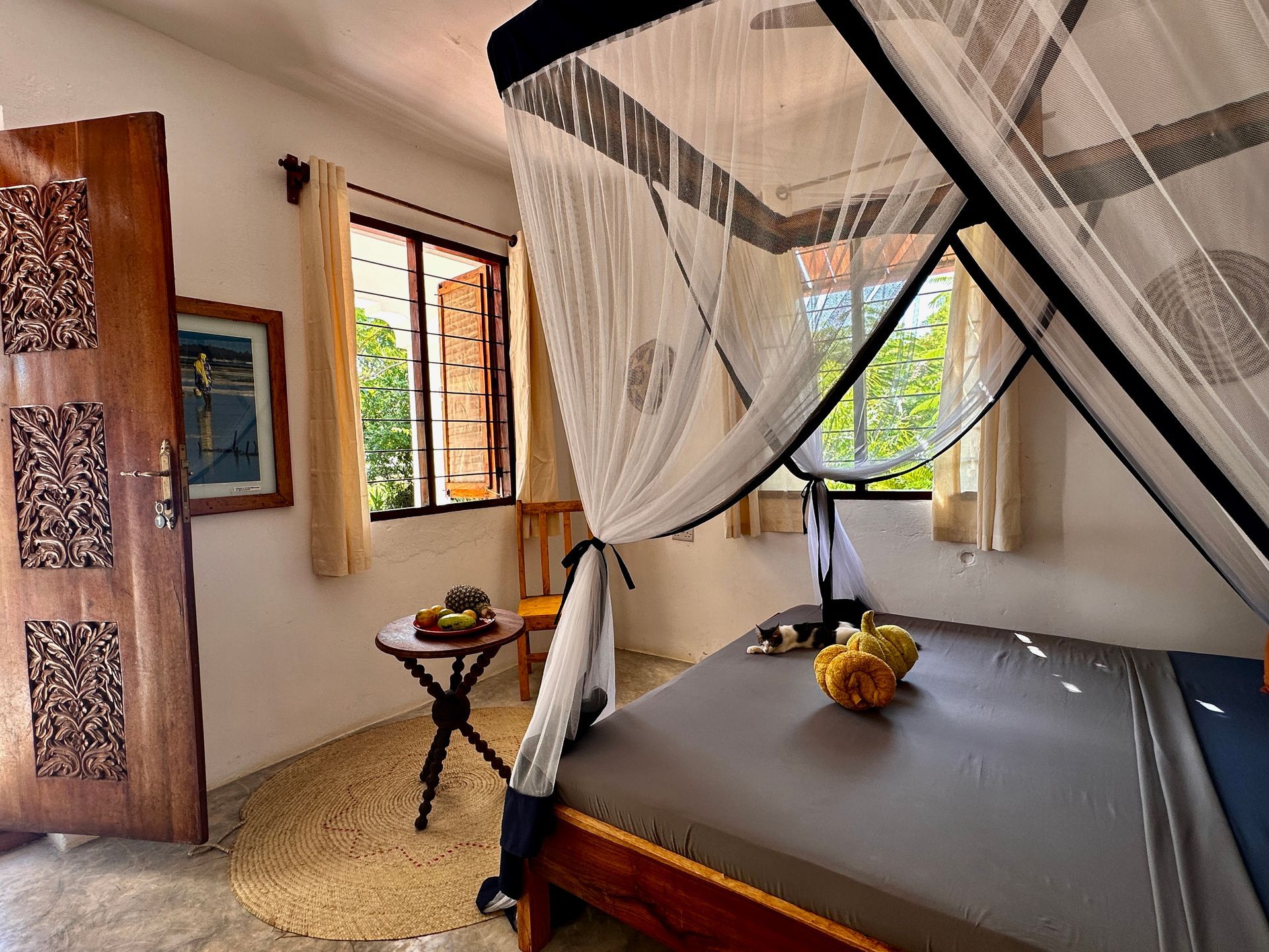 A bedroom with a canopy bed and a table