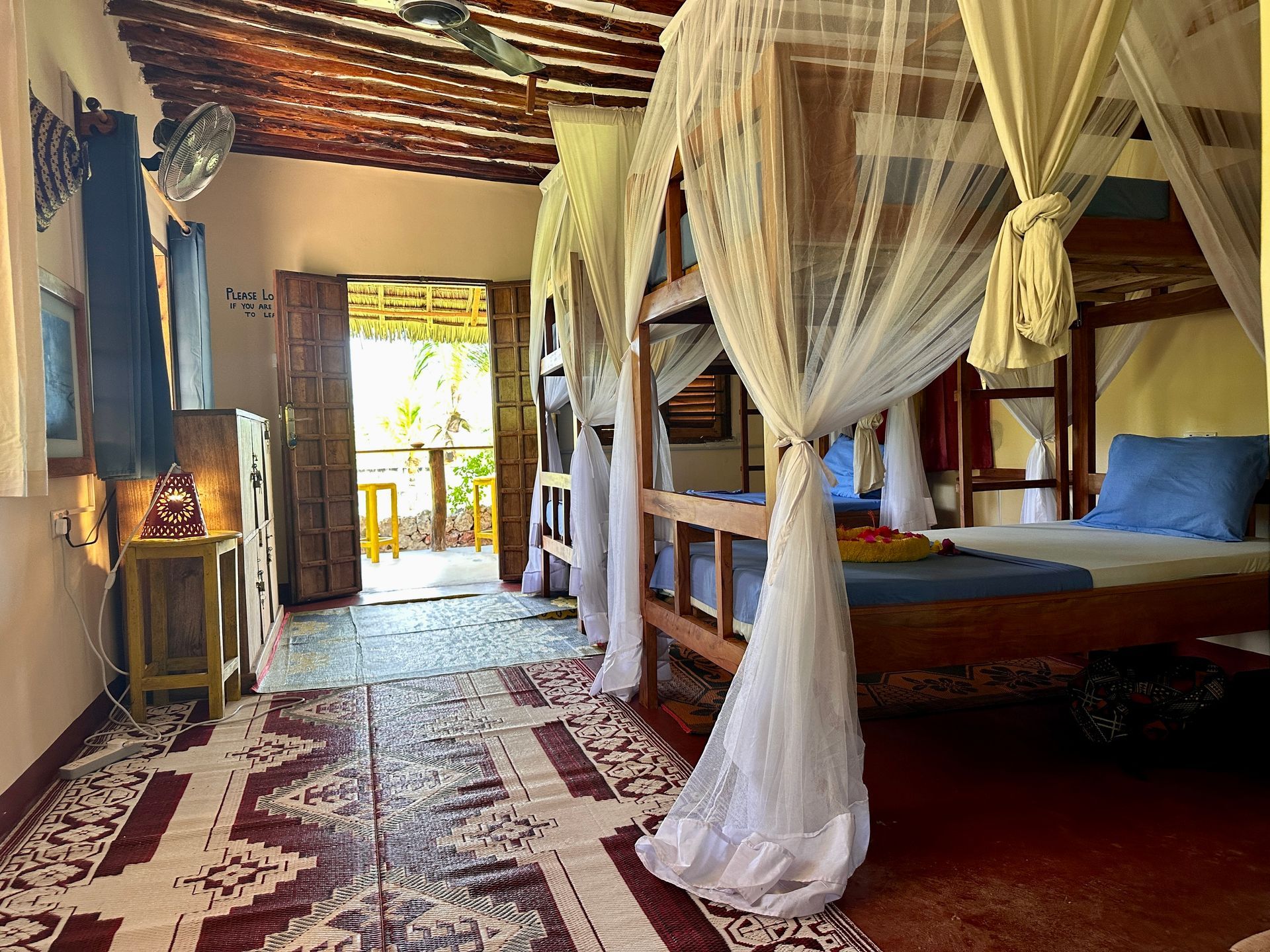 A room with bunk beds and a mosquito net.