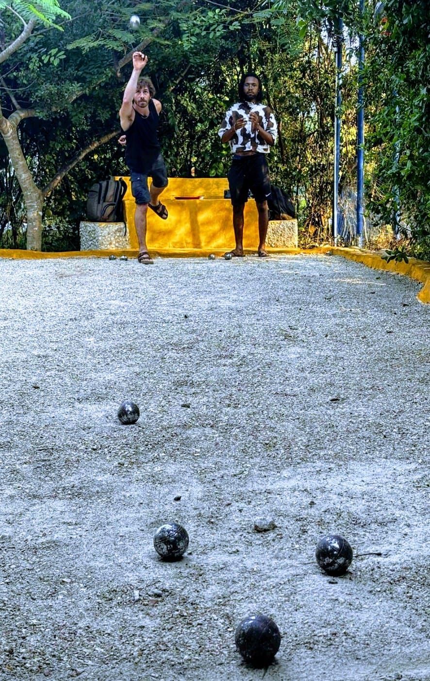 A sign in the woods points to petanque and yoga