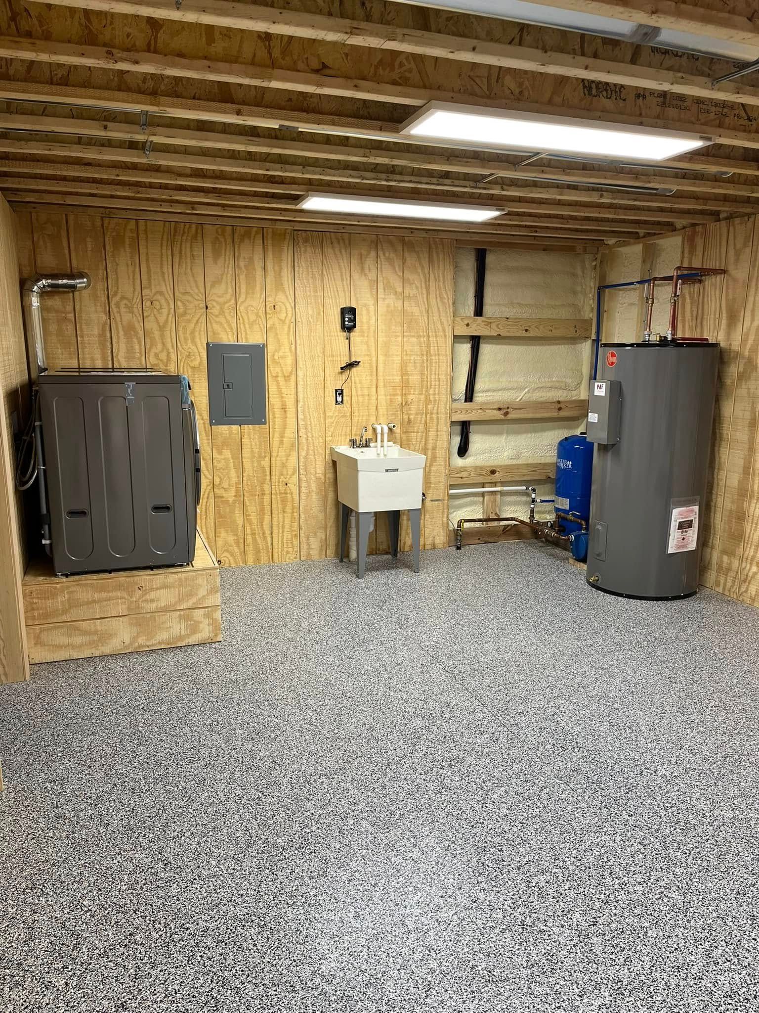 A basement with a sink and a water heater.