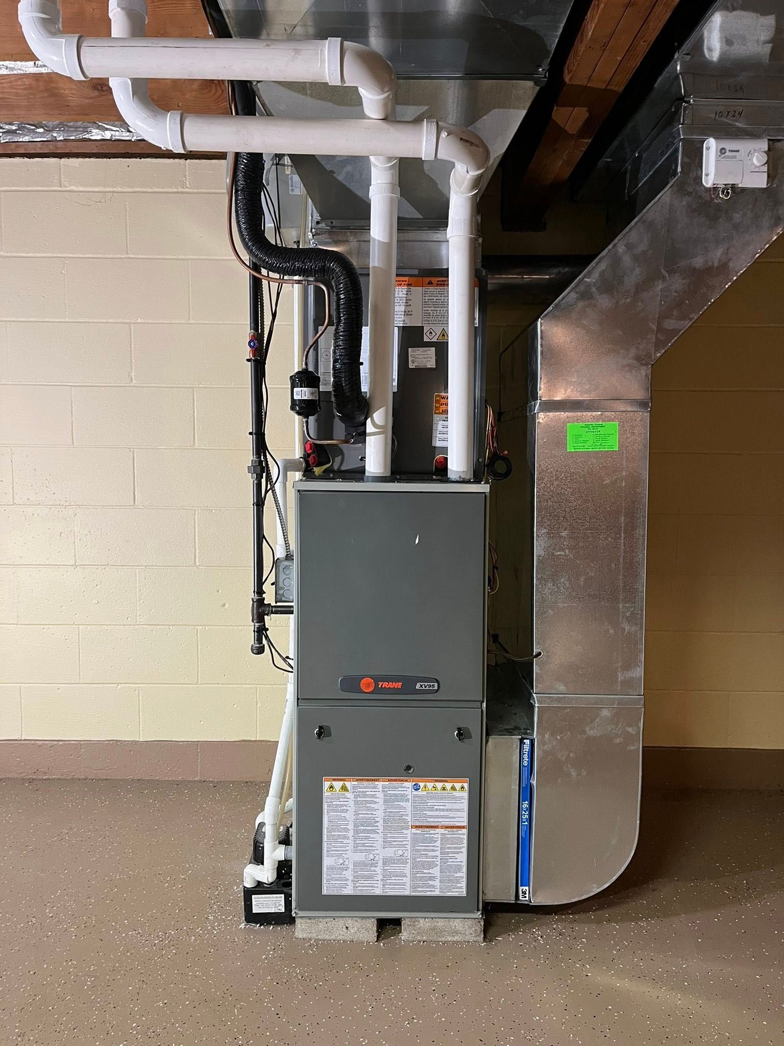 A heating and cooling system is installed in a basement.