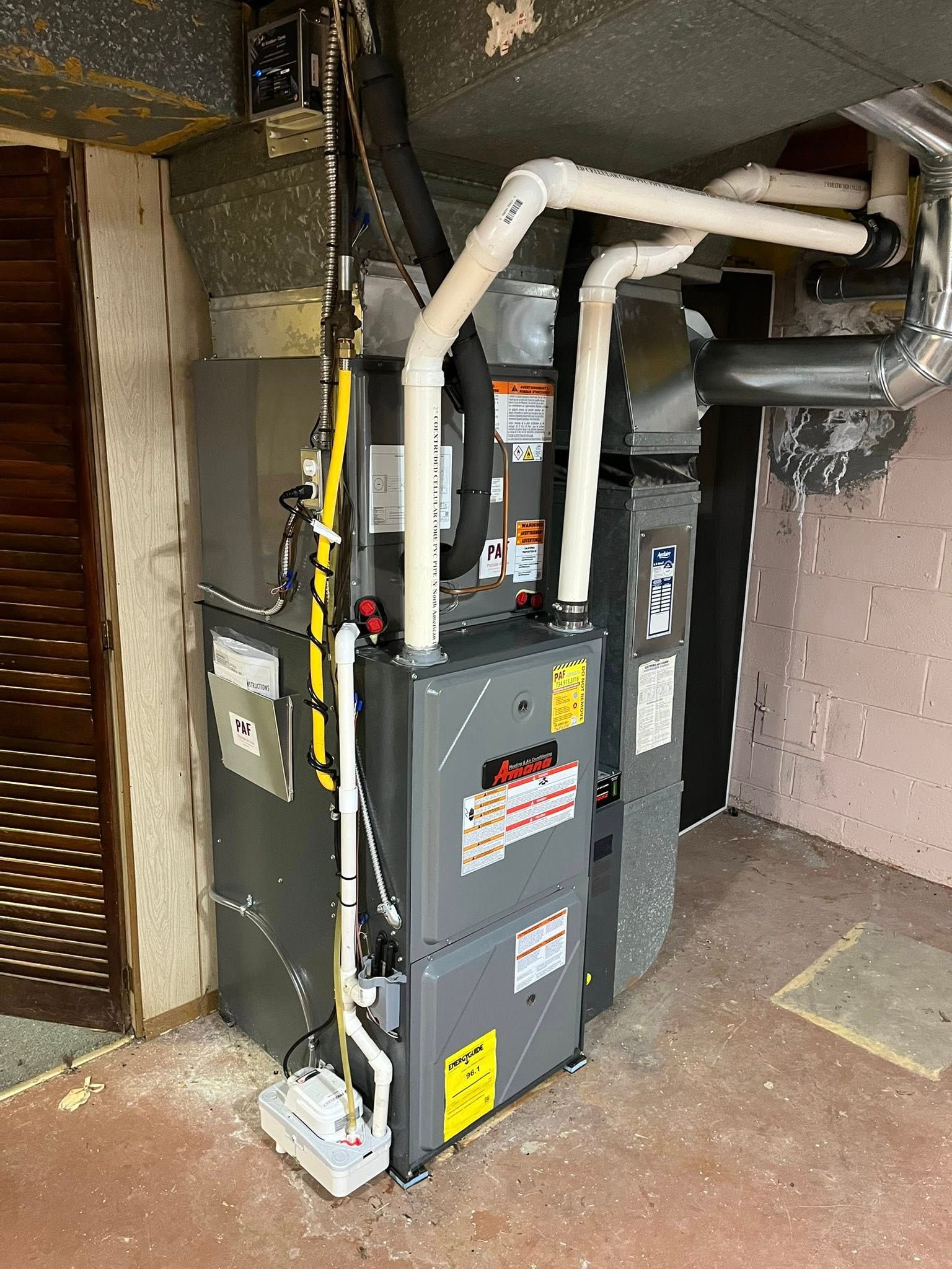 A heating and cooling system is installed in a basement.