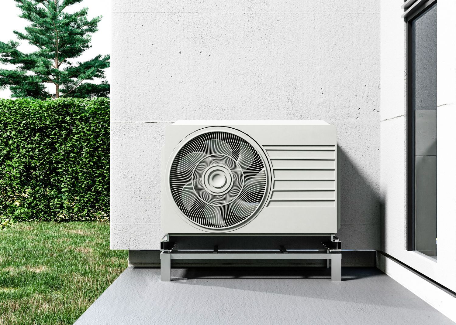 Outdoor air conditioner unit beside a modern white house wall and patio