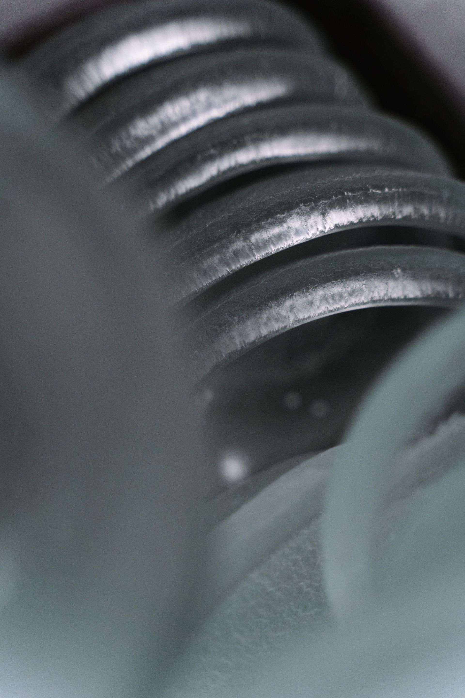 Close-up of black corrugated tubing with glossy ridges