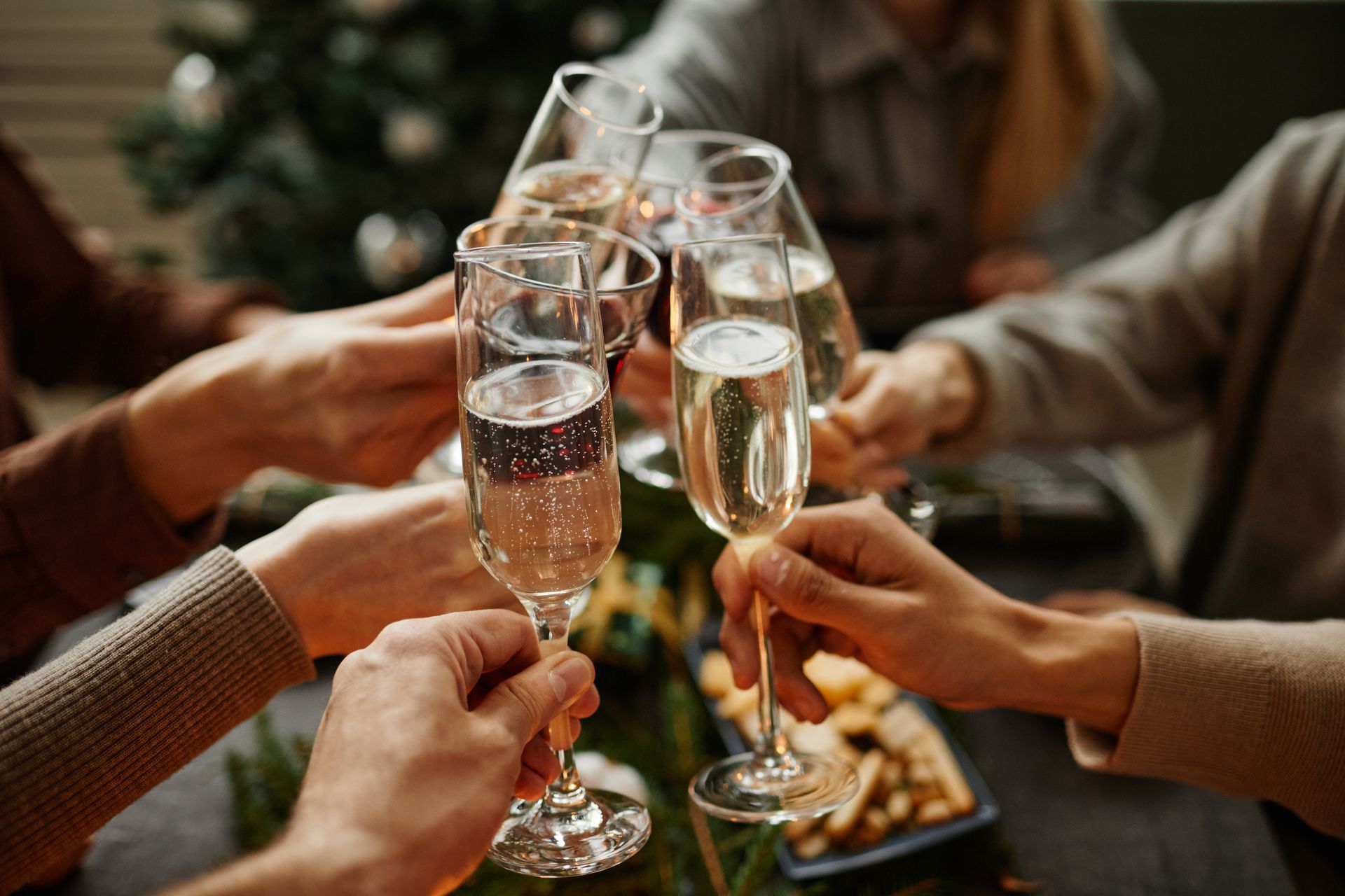 photo of hands holding champagne glasses