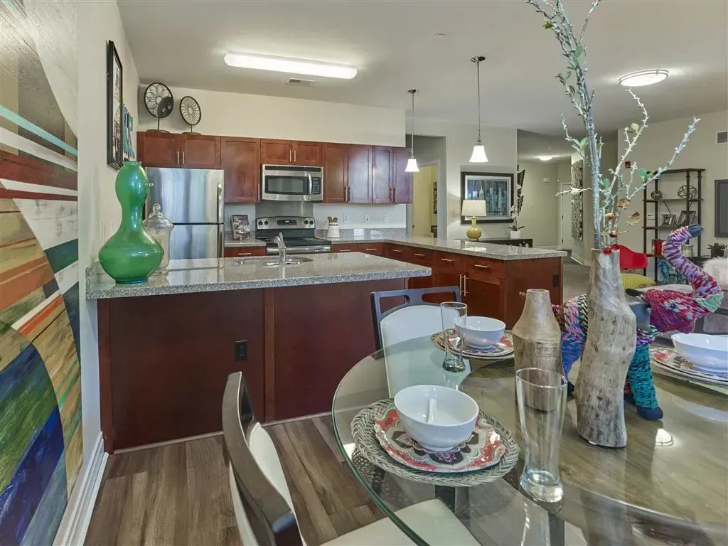 Dining area photo with kitchen in the background
