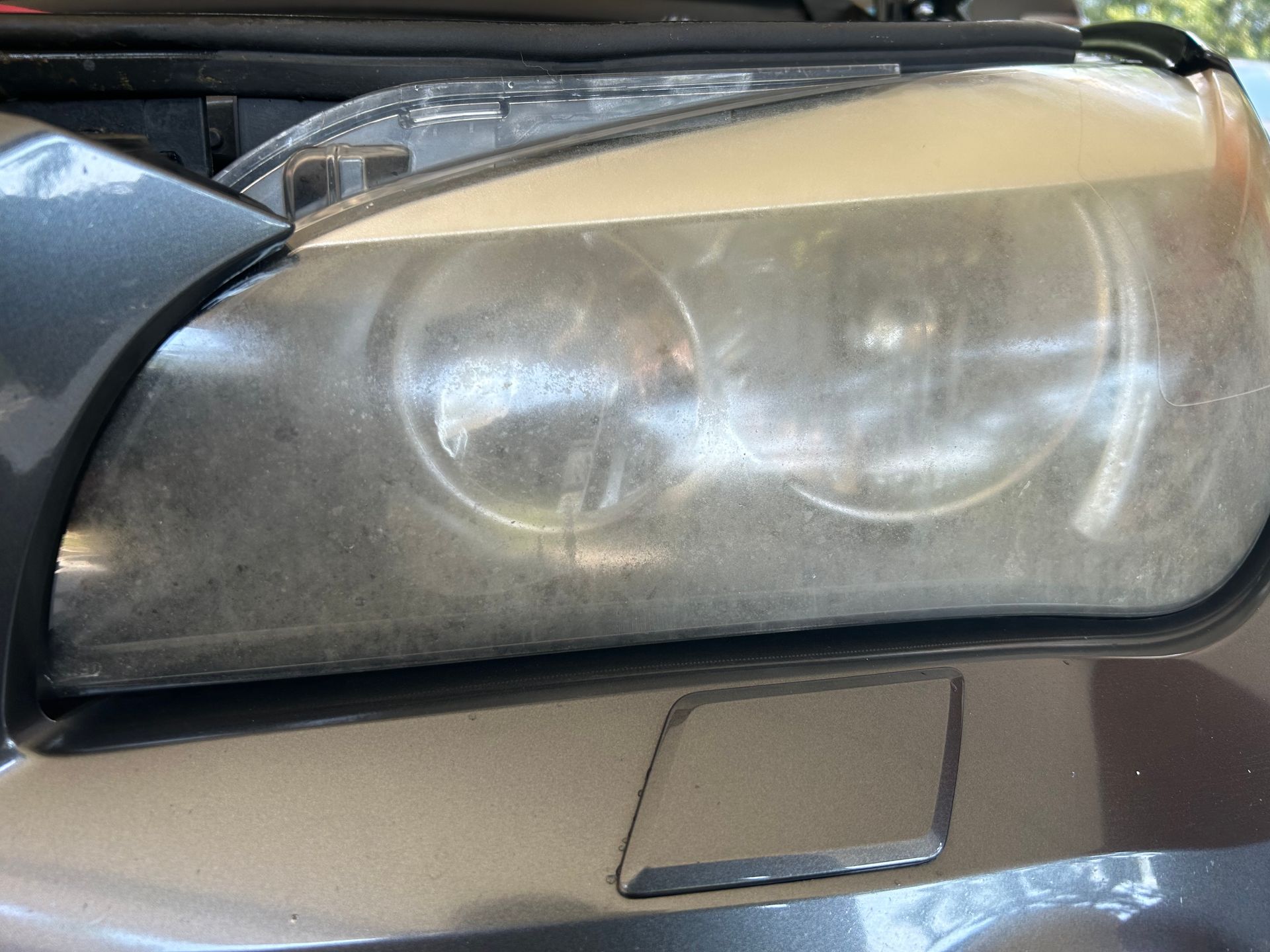 Cloudy, yellowed car headlight.