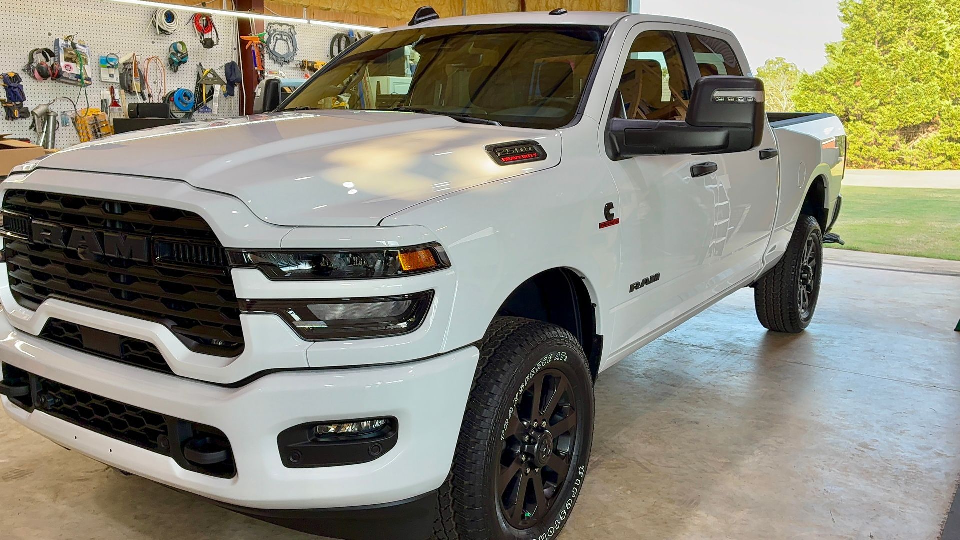 White Ram truck with black accents parked inside, bright lighting.
