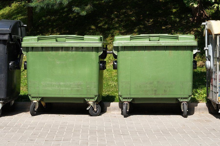 two identical garbage dumpsters