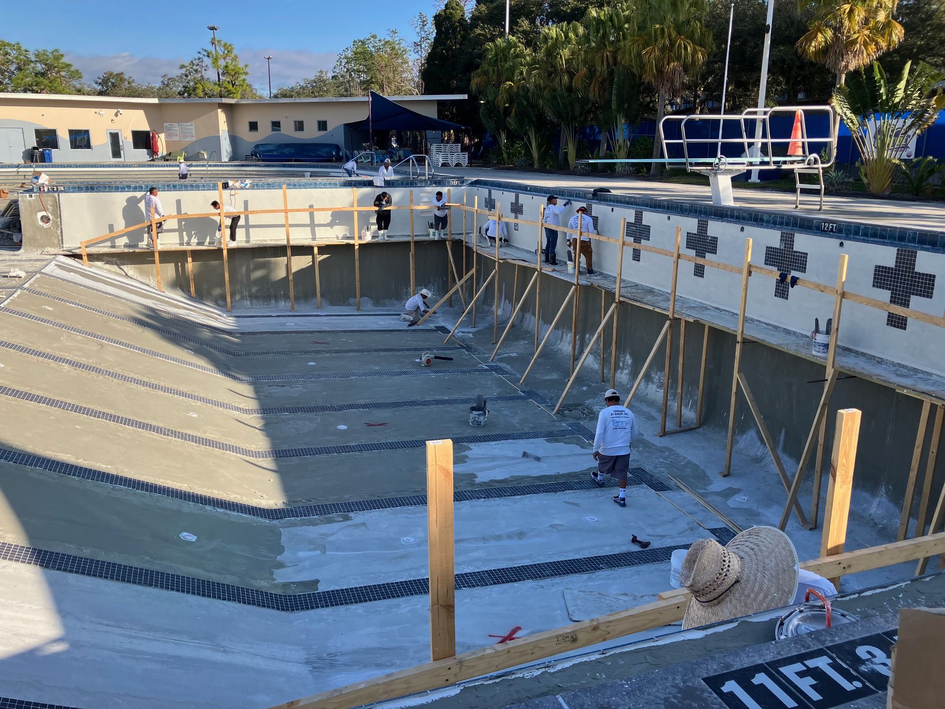 A group of people are working on a swimming pool.