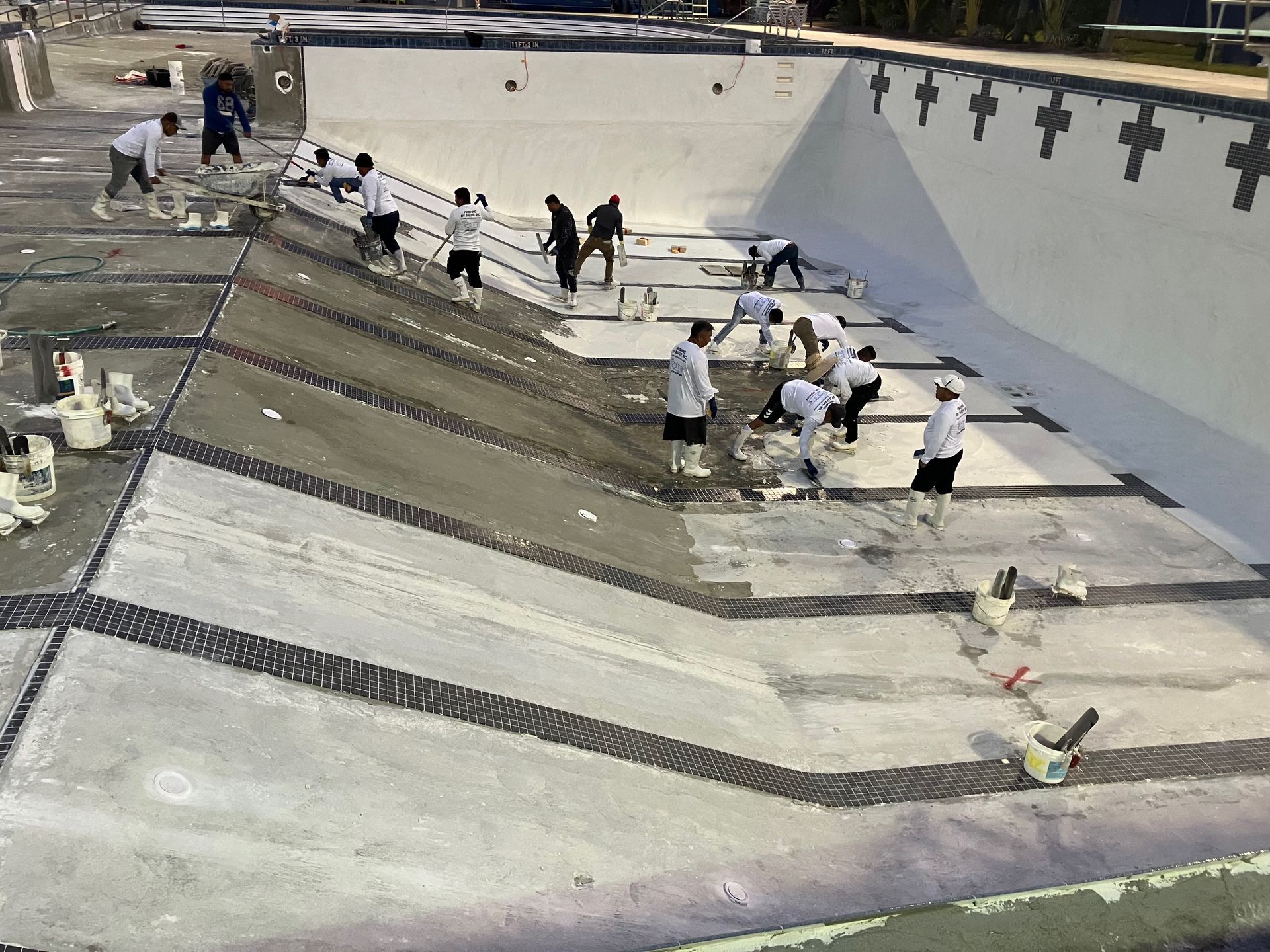 A group of people are working on a swimming pool.