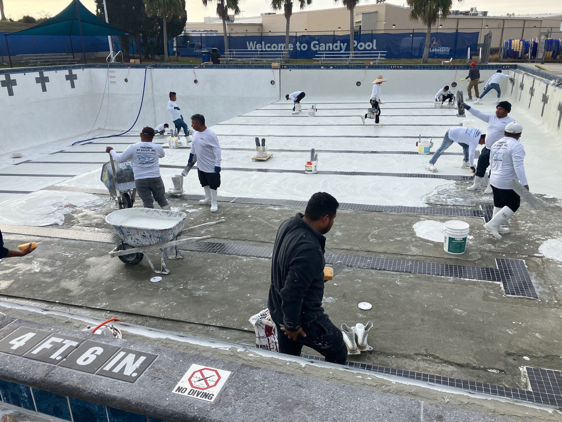 A group of people are working on a swimming pool