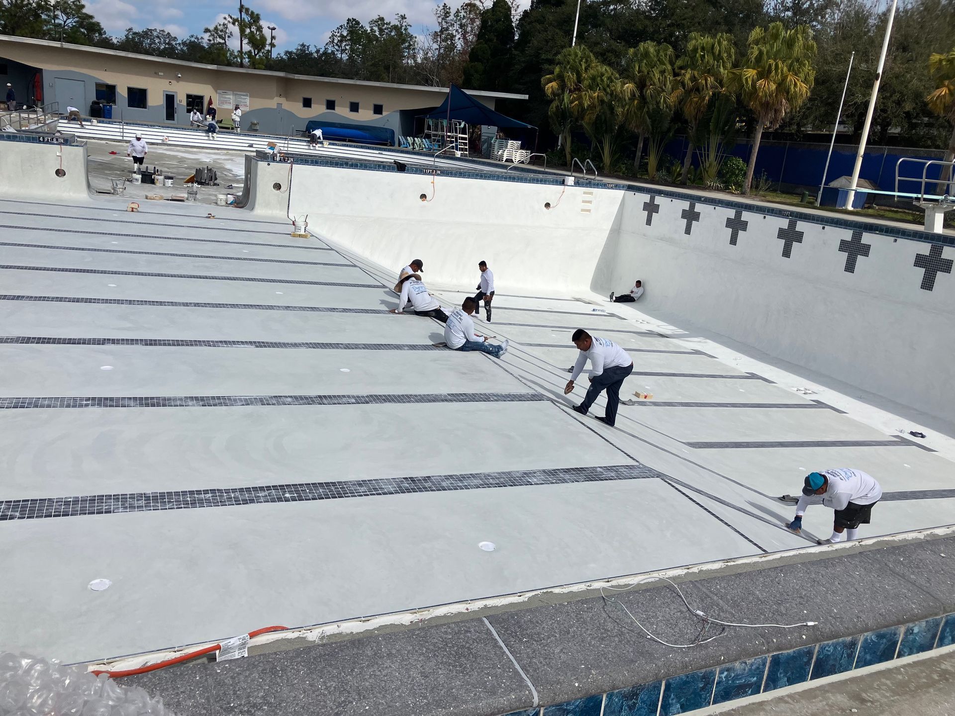 A group of people are working on a swimming pool