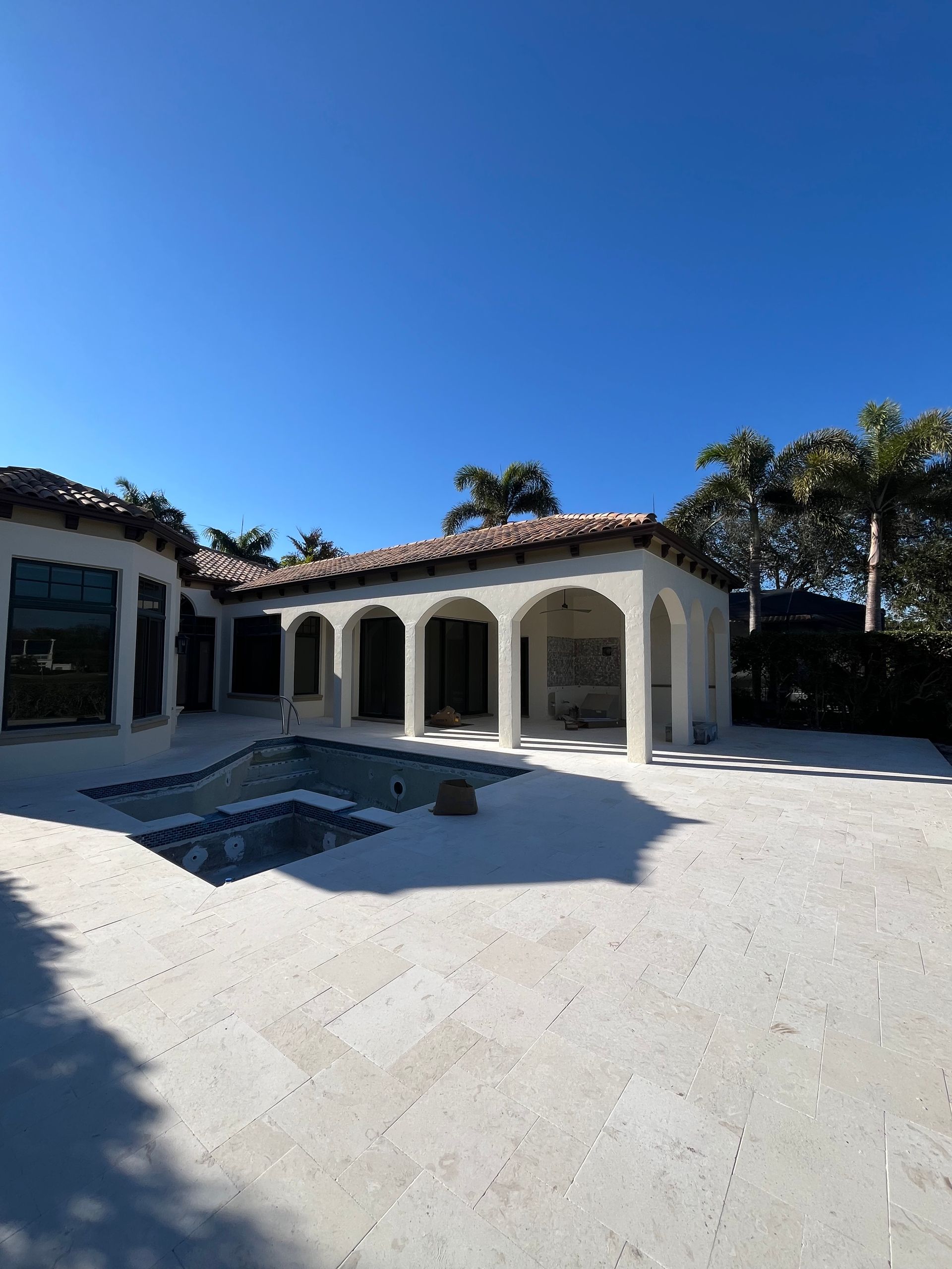 A large white house with a pool in the backyard