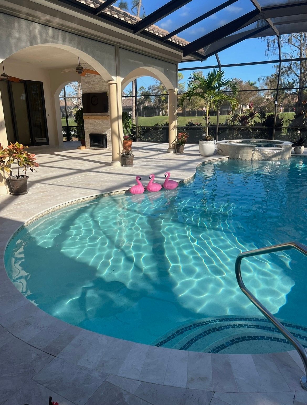 A large swimming pool with pink flamingos in it