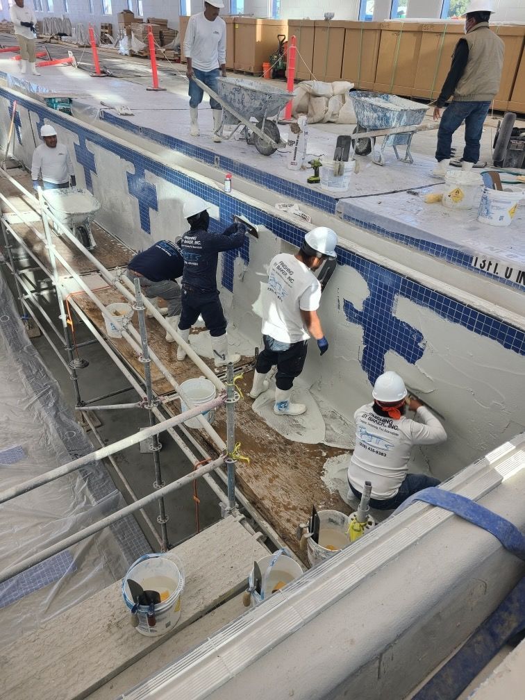A group of people are working on a swimming pool.