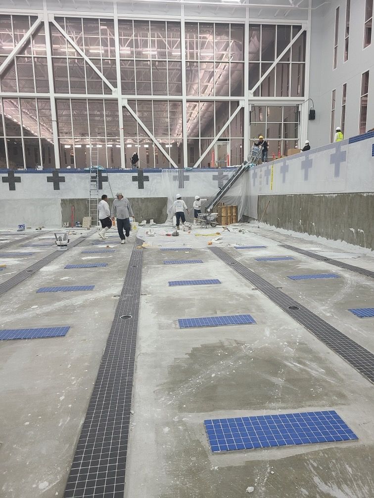 A group of people are working on a swimming pool.