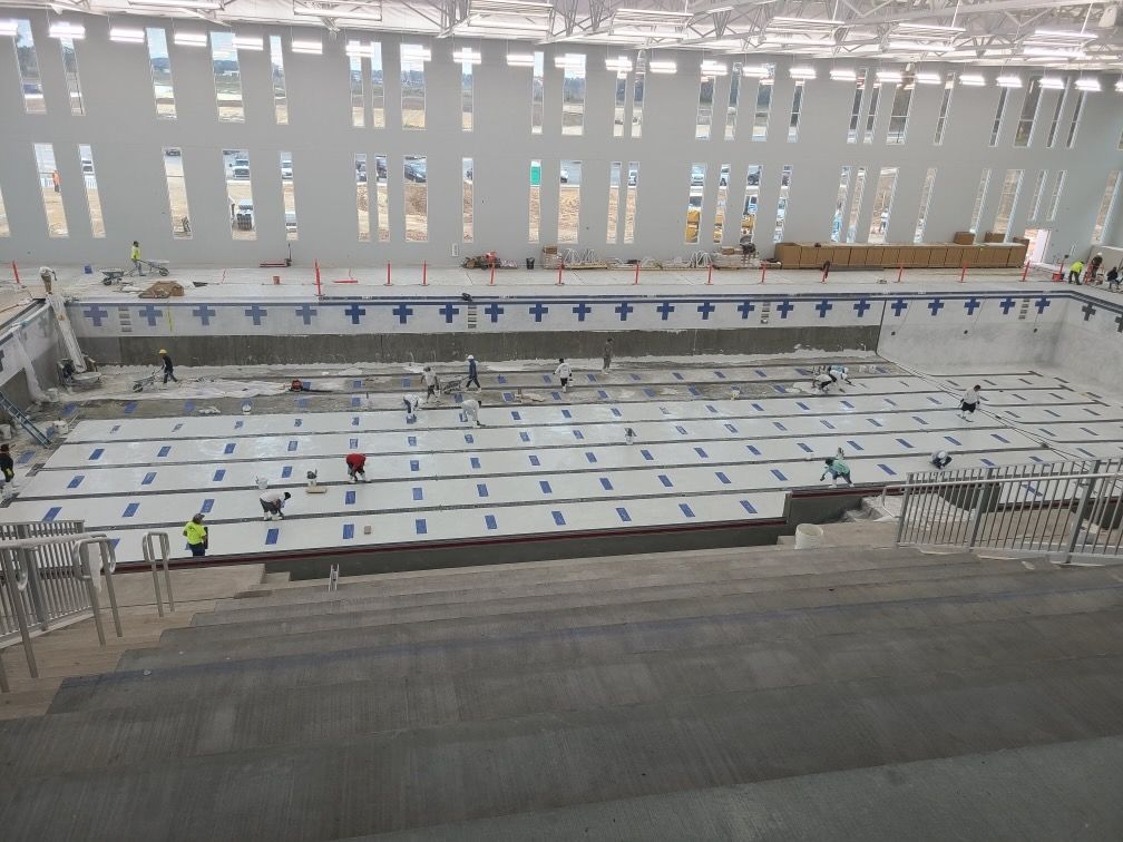A large swimming pool is being built in a large building