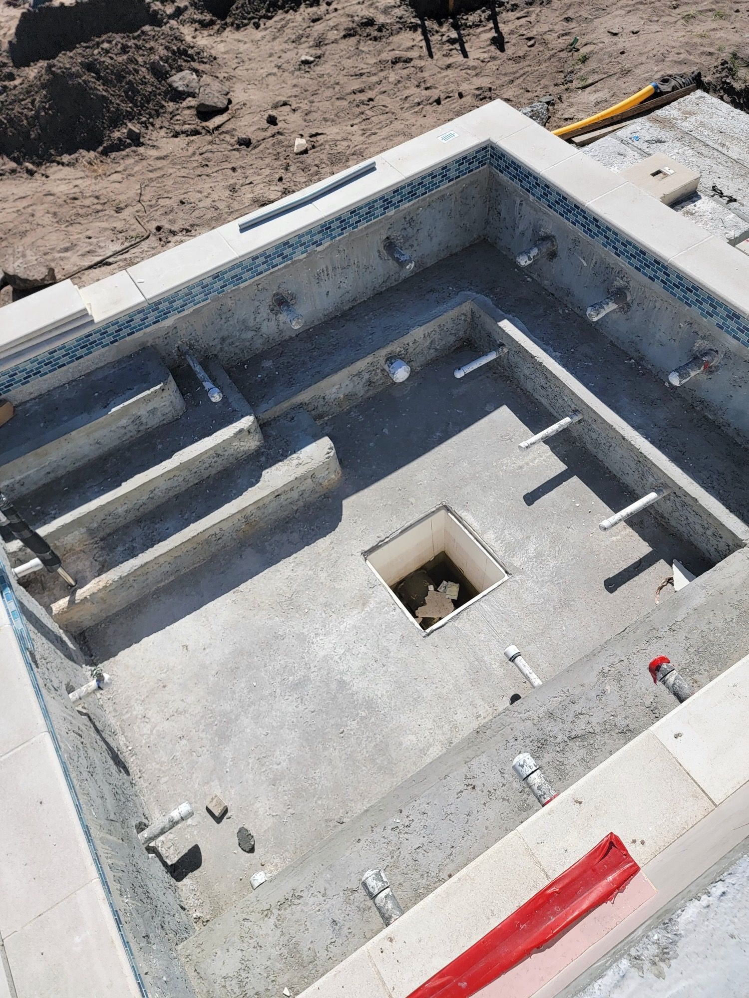 An aerial view of a swimming pool under construction.