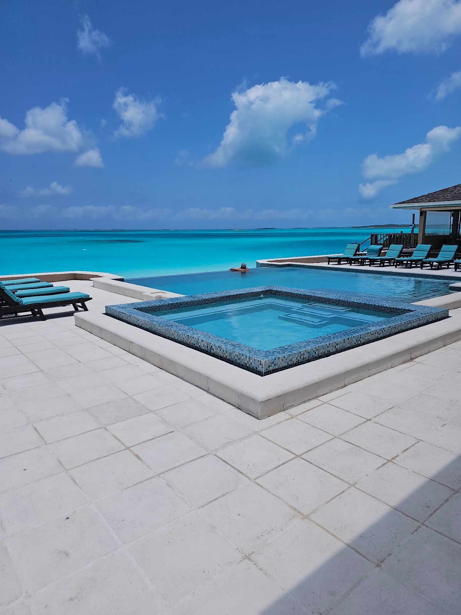 A large swimming pool with a view of the ocean