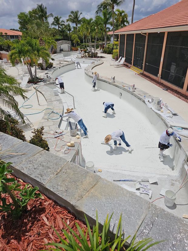A group of people are working on a swimming pool.