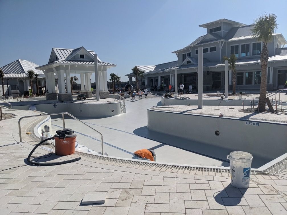 A large house with a swimming pool in front of it