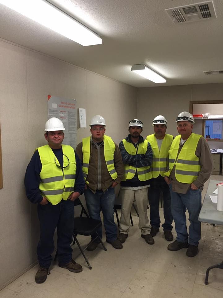 A white truck is parked in the middle of a grassy field.