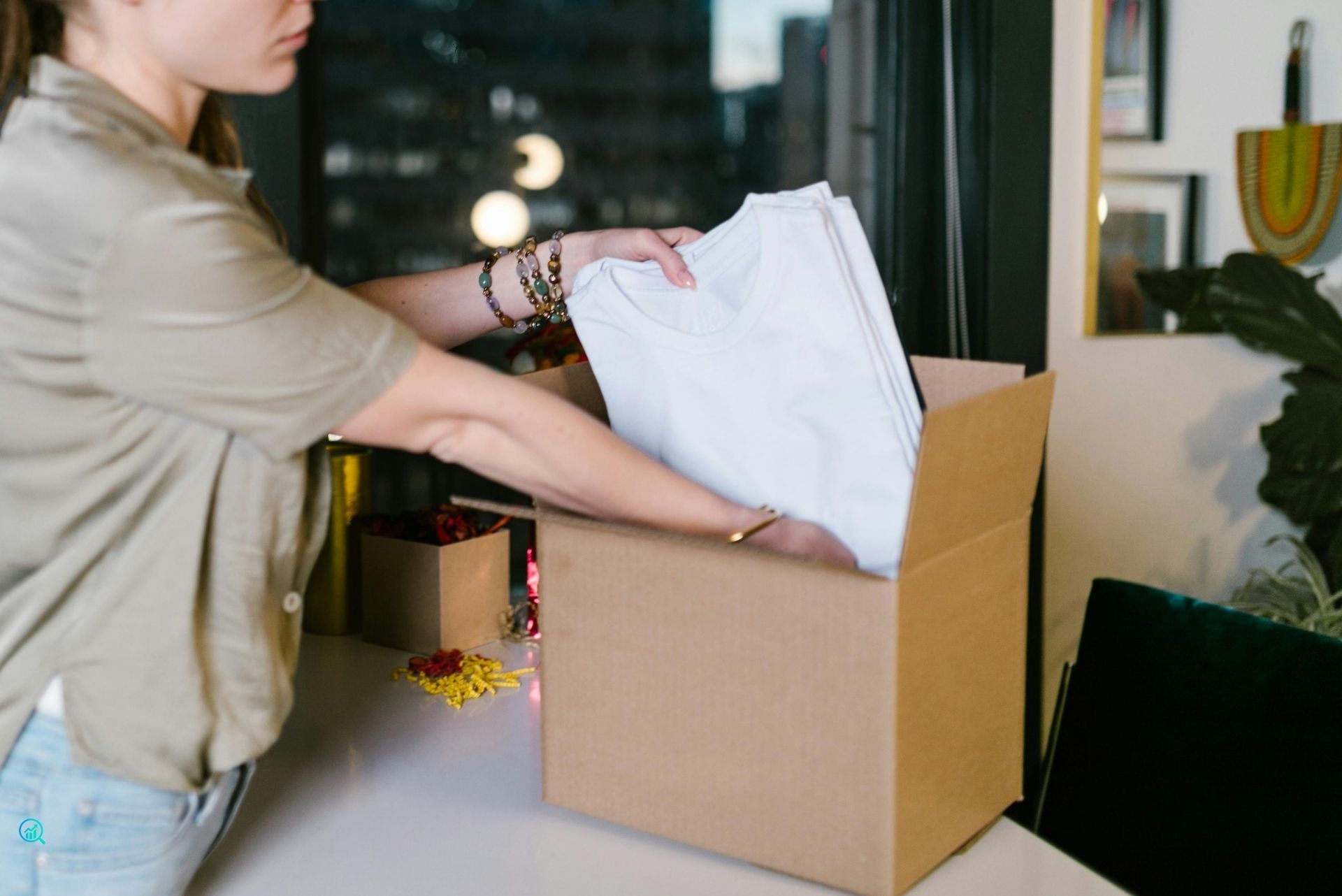 Small business owner packing online orders, representing e-commerce marketing and lead-generation services by Growth Reach Digital.