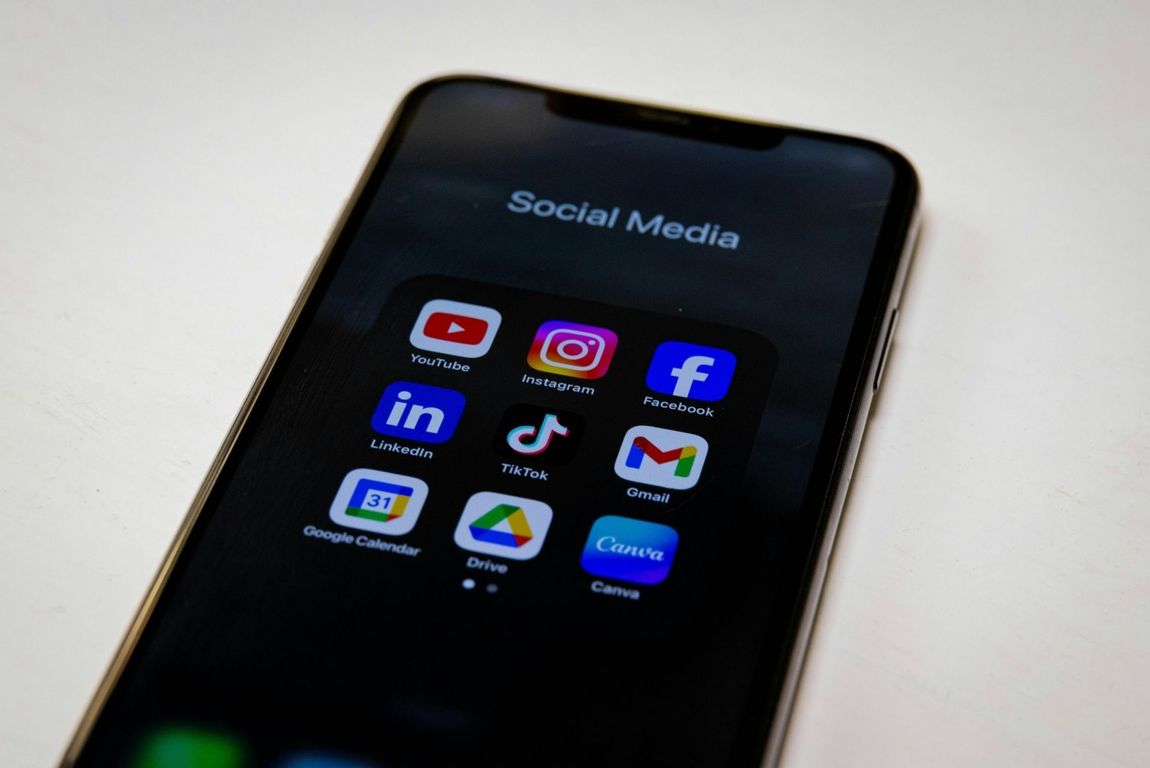 Small business owner creating a social media ad video for Facebook, Instagram, TikTok, and YouTube — managed by Growth Reach Digital to increase brand visibility and leads.