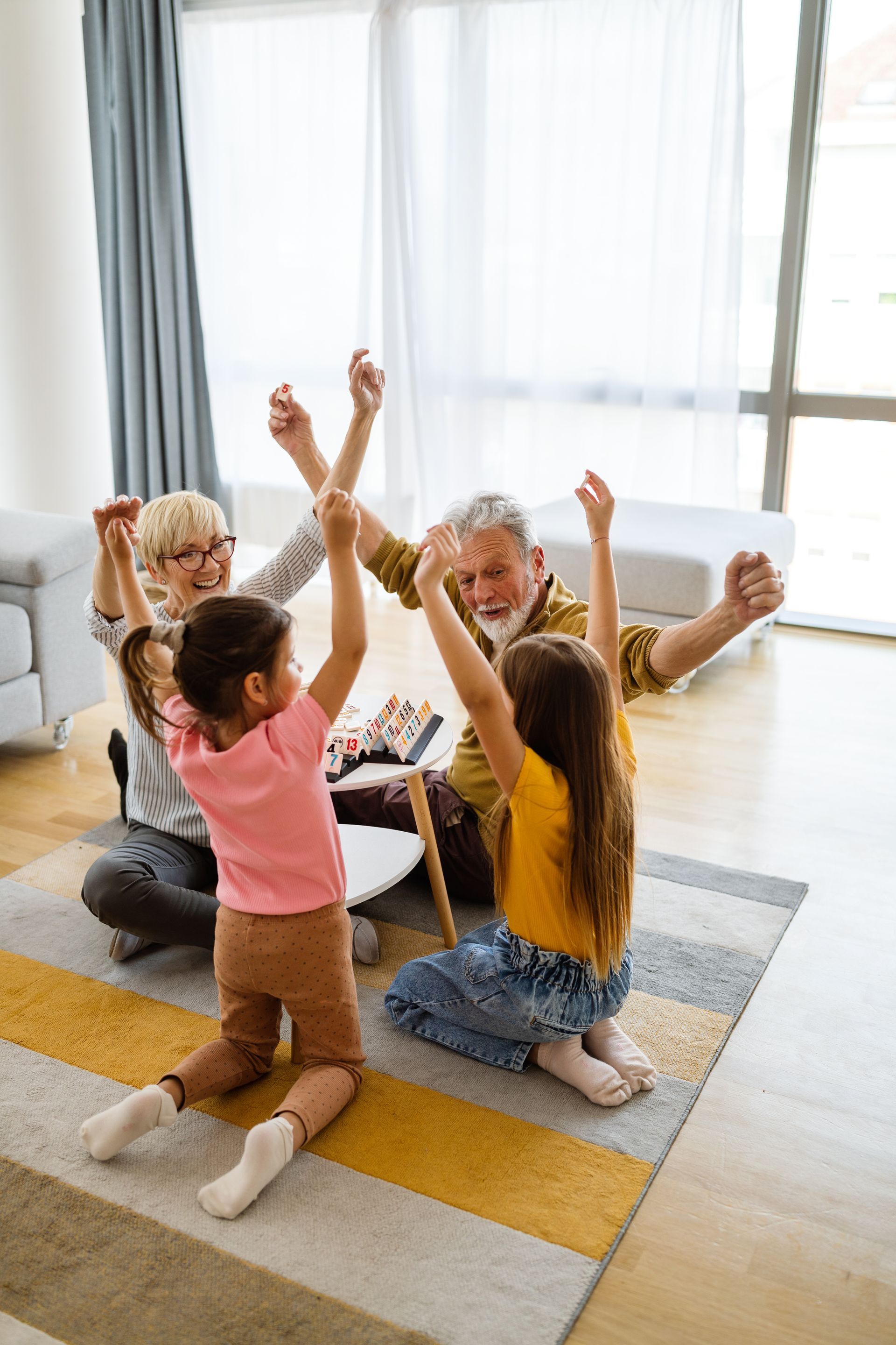 A family is giving each other a high five in a living room.