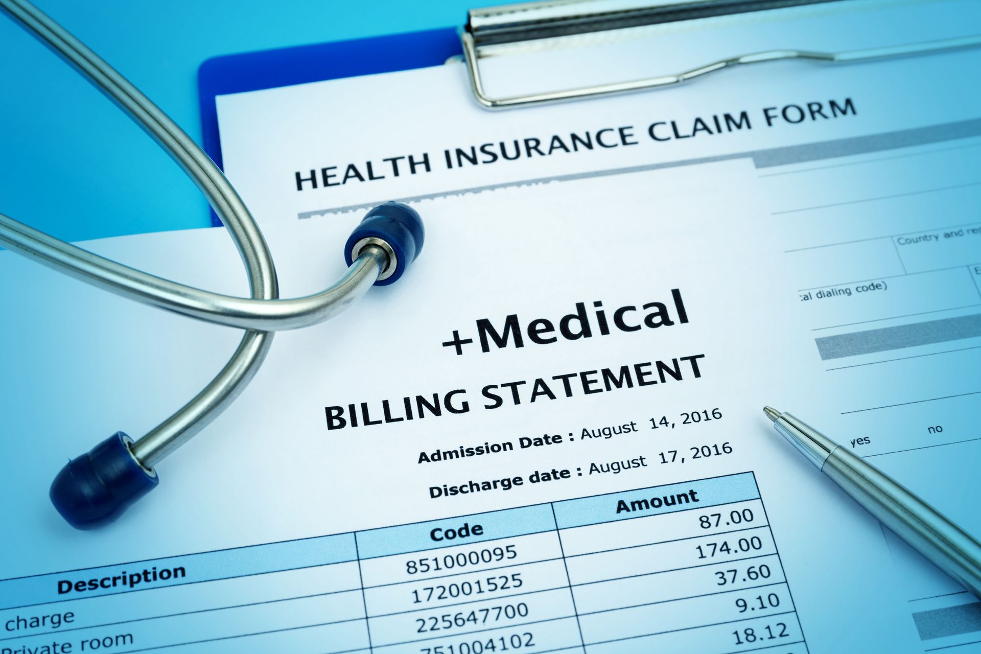 Medical billing statement and health insurance claim form with a stethoscope and pen.